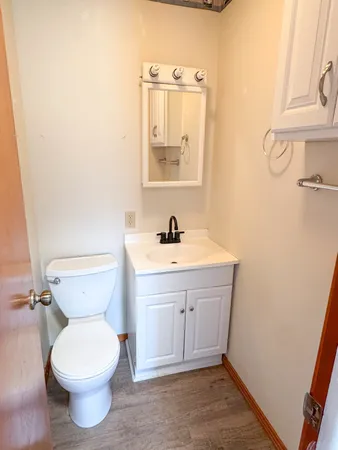 a bathroom with a toilet sink and mirror