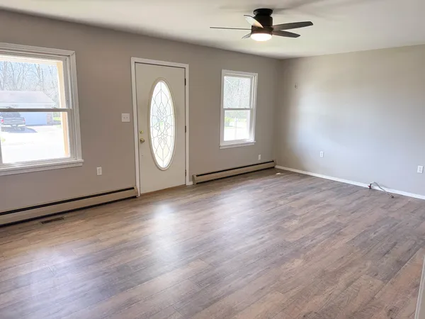 wooden floor in an empty room with a window