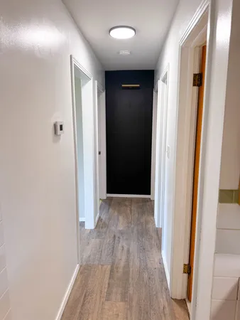 a view of hallway with wooden floor