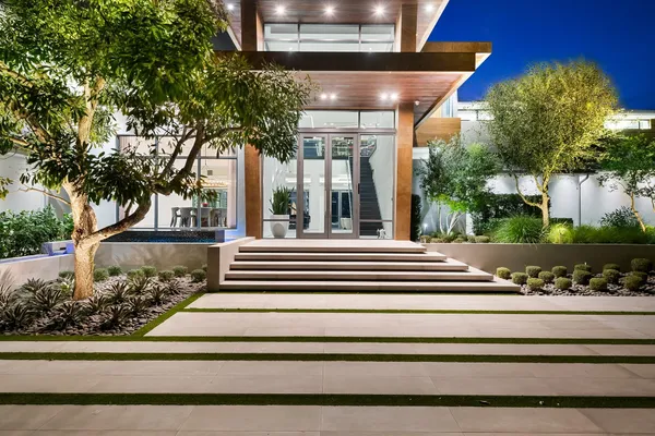 a living room with furniture a rug and a floor to ceiling window