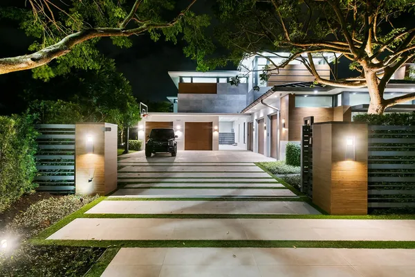 an aerial view of a house with a garden and lake view