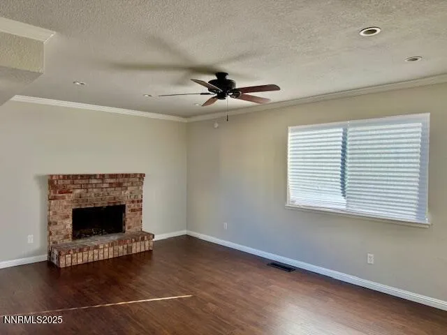 a living room with a fireplace and a ceiling fan