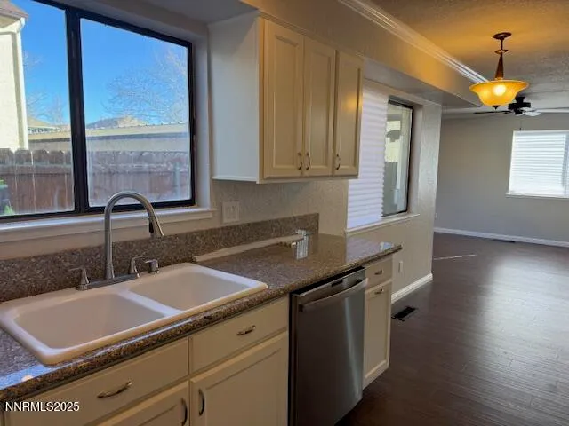 a kitchen with a sink cabinets and window