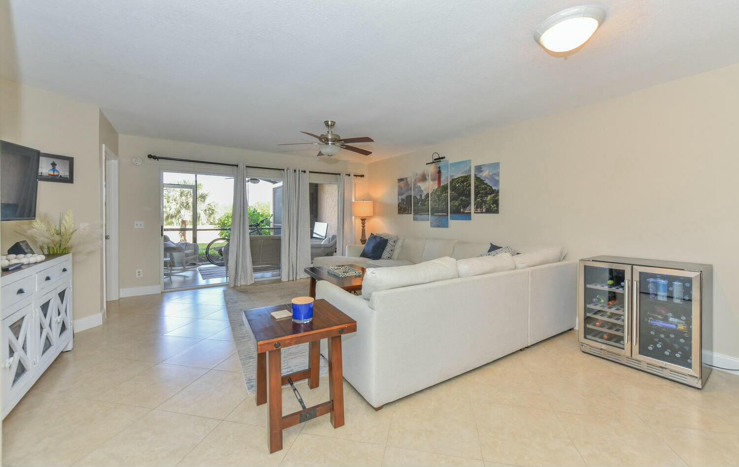275 Palm Avenue, Unit B106 Jupiter, FL 33477 - Photo 12 of 43 a living room with furniture and a flat screen tv