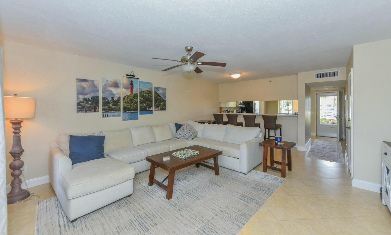 275 Palm Avenue, Unit B106 Jupiter, FL 33477 - Photo 14 of 43 a living room with furniture and a chandelier