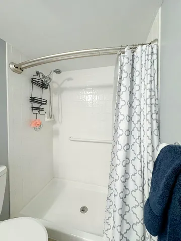 a bathroom with a shower curtain and a toilet