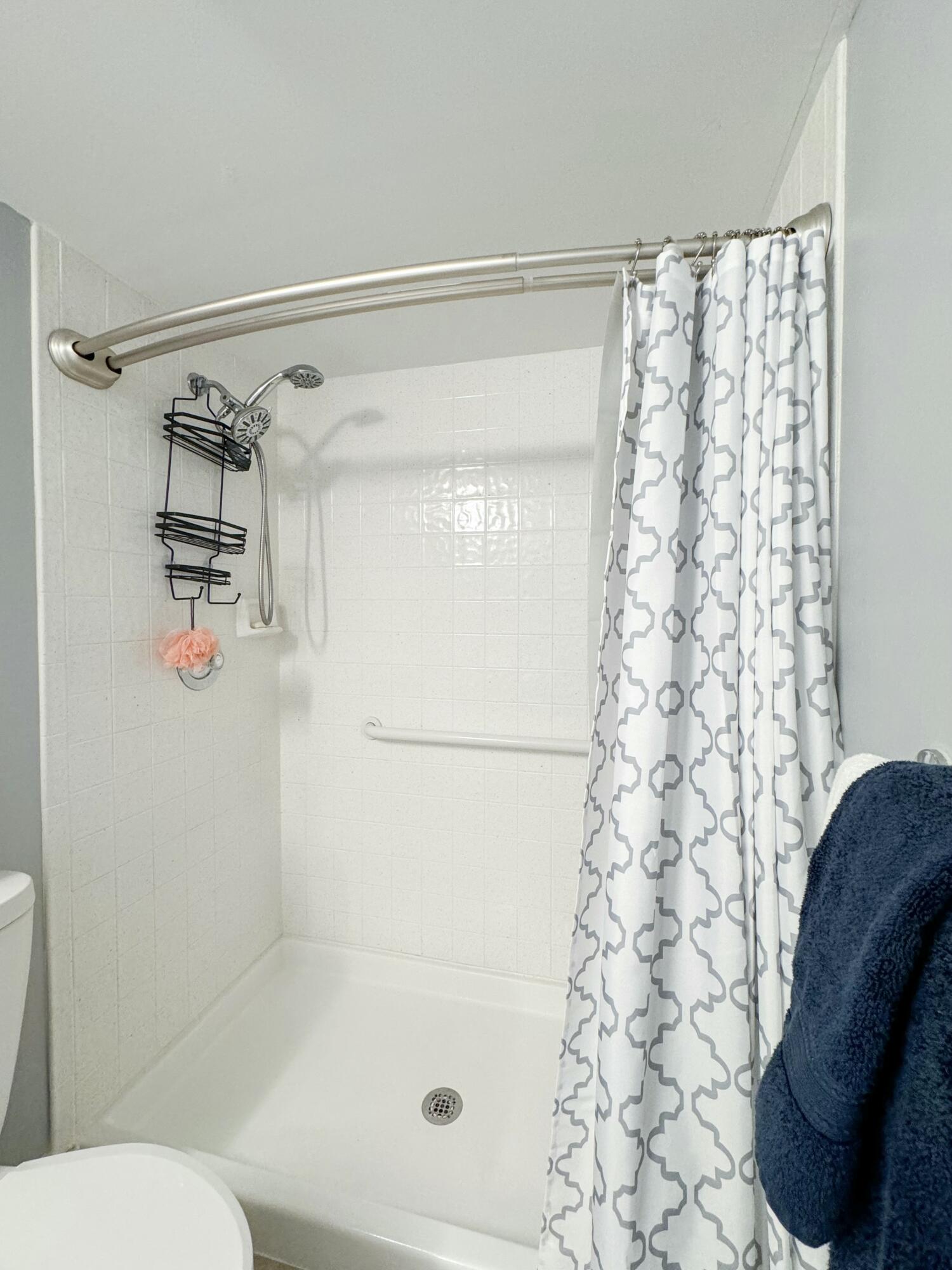 275 Palm Avenue, Unit B106 Jupiter, FL 33477 - Photo 20 of 43 a bathroom with a shower curtain and a toilet