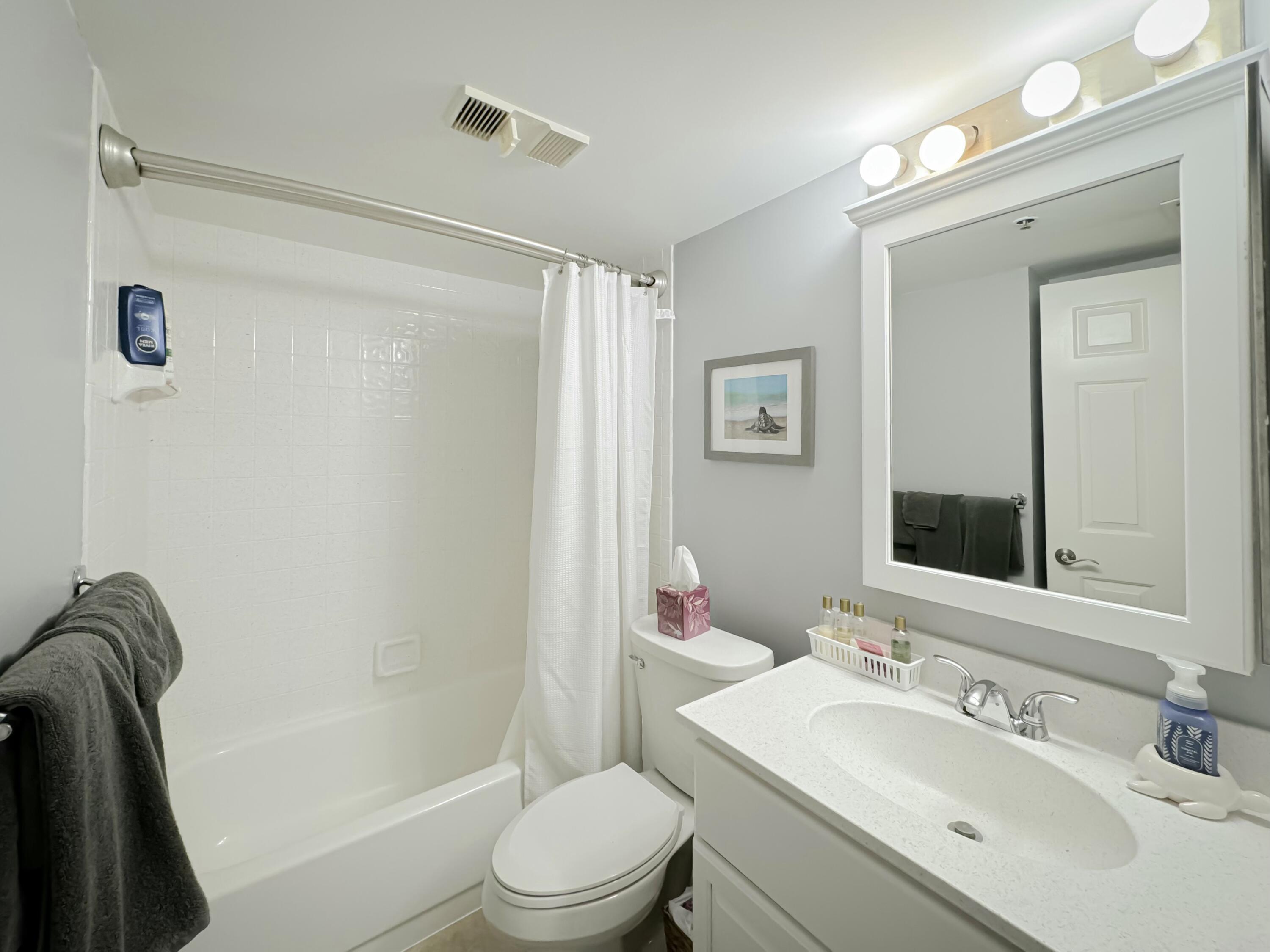 275 Palm Avenue, Unit B106 Jupiter, FL 33477 - Photo 23 of 43 a bathroom with a sink toilet and shower