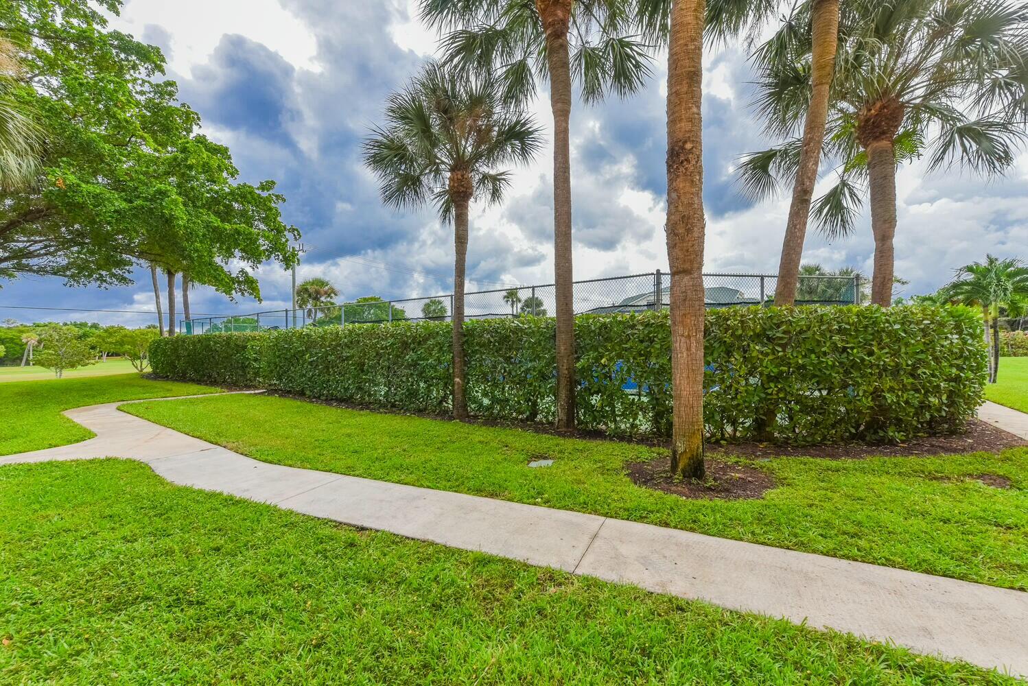 275 Palm Avenue, Unit B106 Jupiter, FL 33477 - Photo 38 of 43 a view of a garden with palm trees