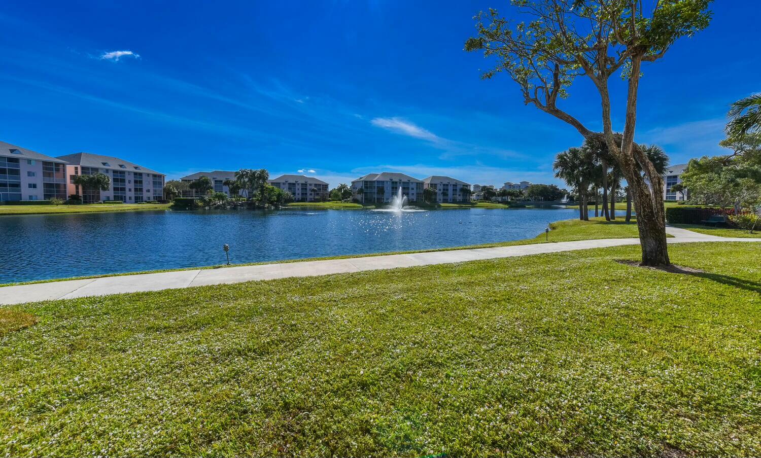 275 Palm Avenue, Unit B106 Jupiter, FL 33477 - Photo 40 of 43 a view of a lake with houses in the back