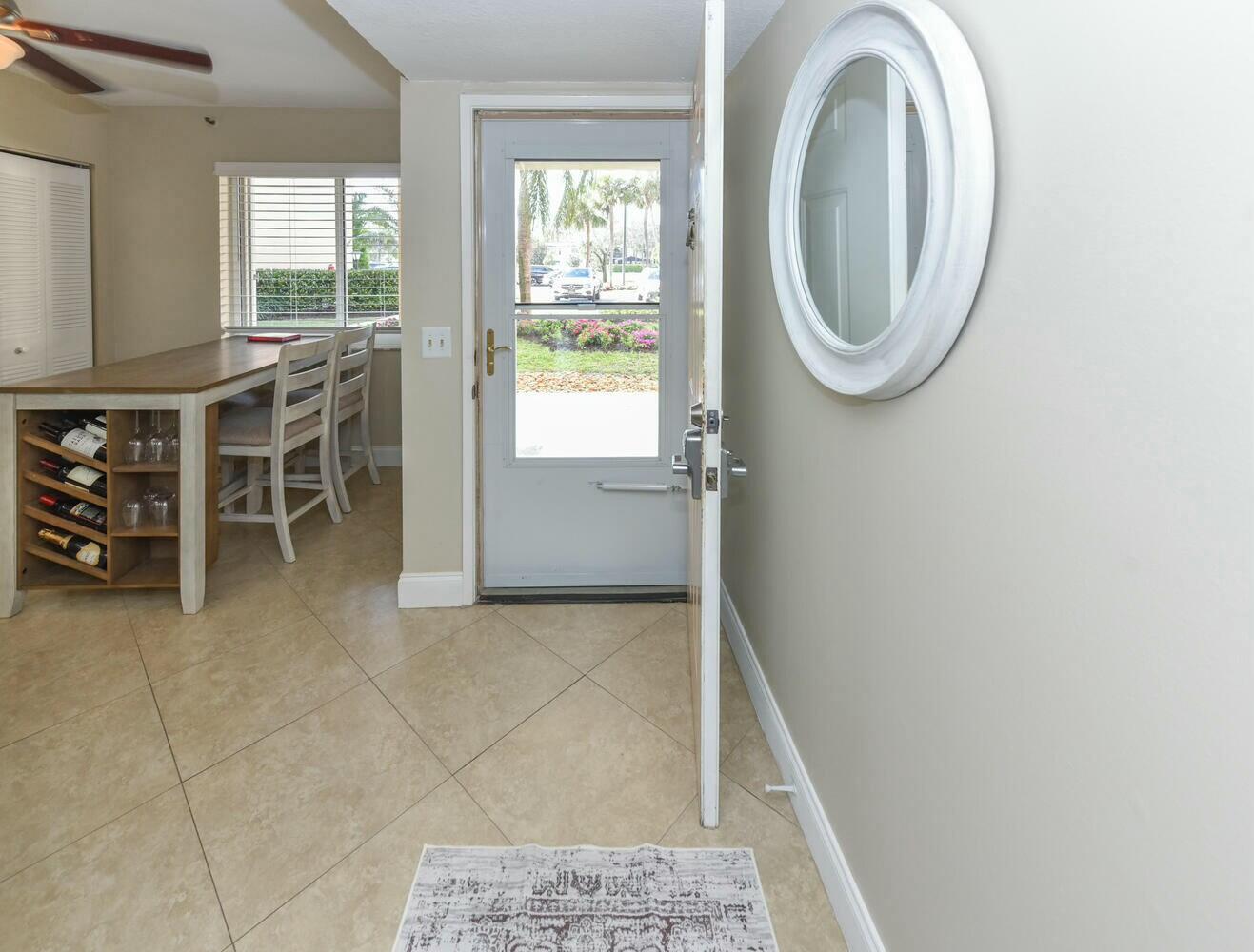 275 Palm Avenue, Unit B106 Jupiter, FL 33477 - Photo 6 of 43 a view of a livingroom with furniture and a window