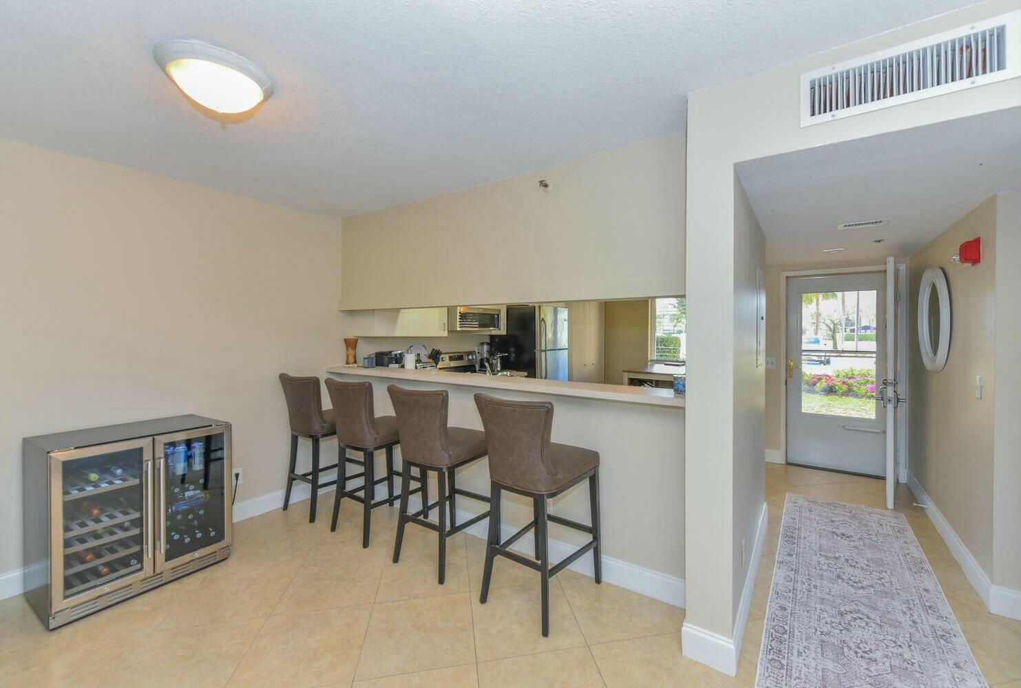 275 Palm Avenue, Unit B106 Jupiter, FL 33477 - Photo 10 of 43 a kitchen with a table and chairs in it