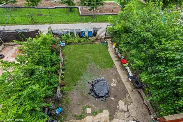 a view of a back yard with potted plants