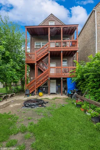 a view of a house with a yard and sitting area