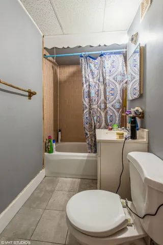 a white toilet sitting next to a bathroom sink and a bathtub