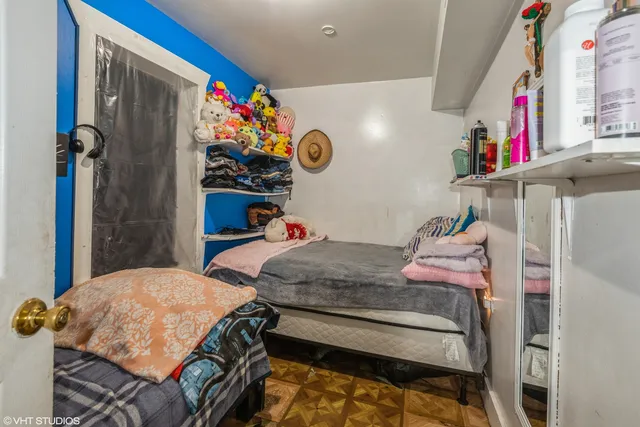 a bedroom with a bed and a dresser