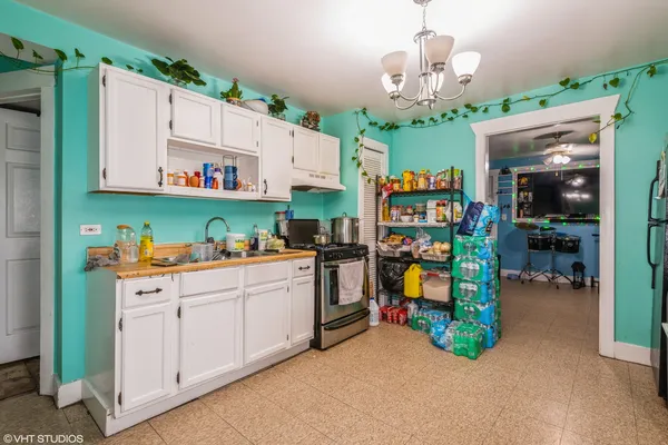 a kitchen that has a lot of cabinets and window