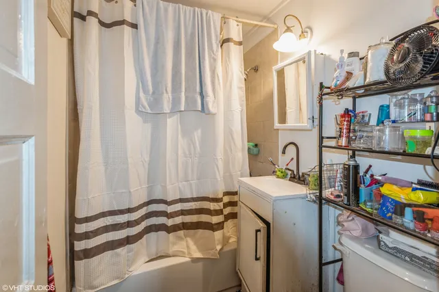 a view of a bedroom with a bed and a window