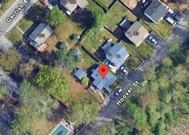 an aerial view of a house with a yard
