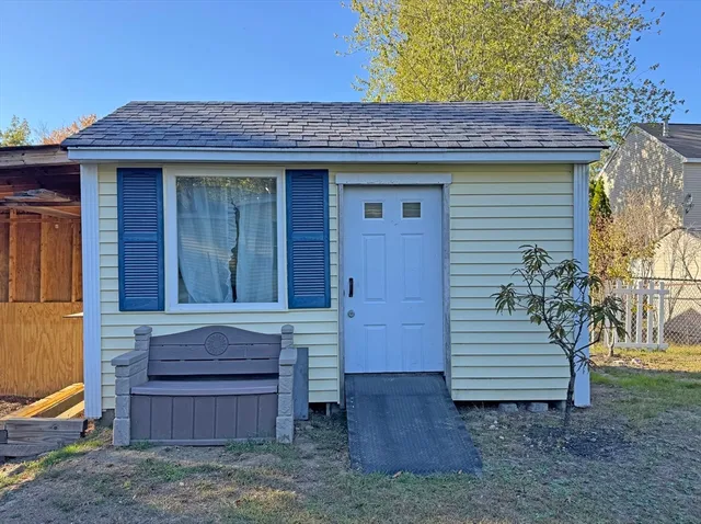 a view of a house with a small tub and wooden fence