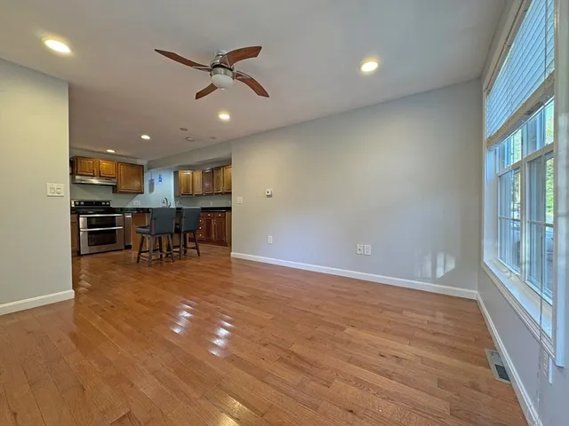 a view of a livingroom with furniture and a ceiling fan