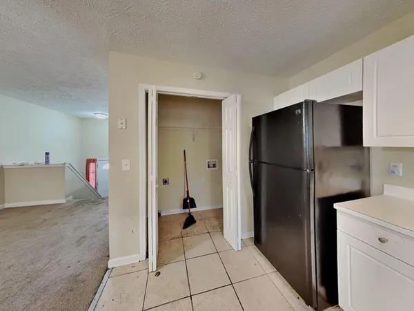 a kitchen with a refrigerator and a sink