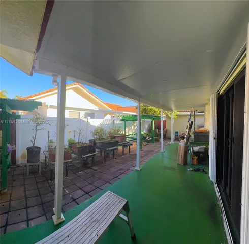 a view of a porch with chairs and backyard