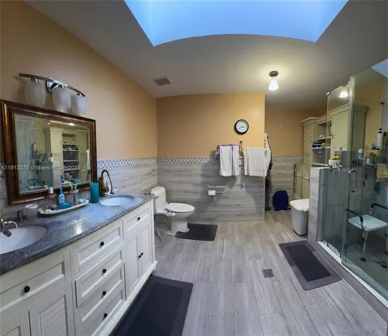a very nice looking room with a large mirror and sink
