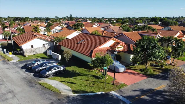 an aerial view of multiple houses with yard