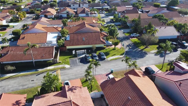 an aerial view of a houses with yard