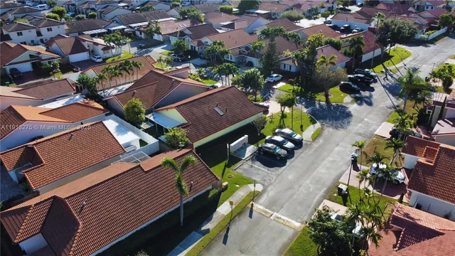 an aerial view of a house with a yard and lake view