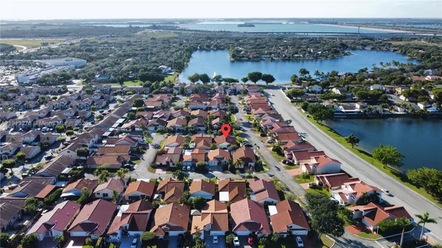 an aerial view of house with outdoor space and lake view