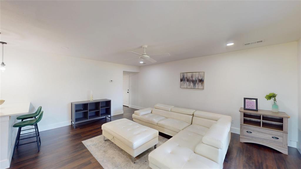 903 Turtle Lake Boulevard, Unit 268 Irving, TX 75060 - Photo 6 of 21 a living room with furniture and a wooden floor