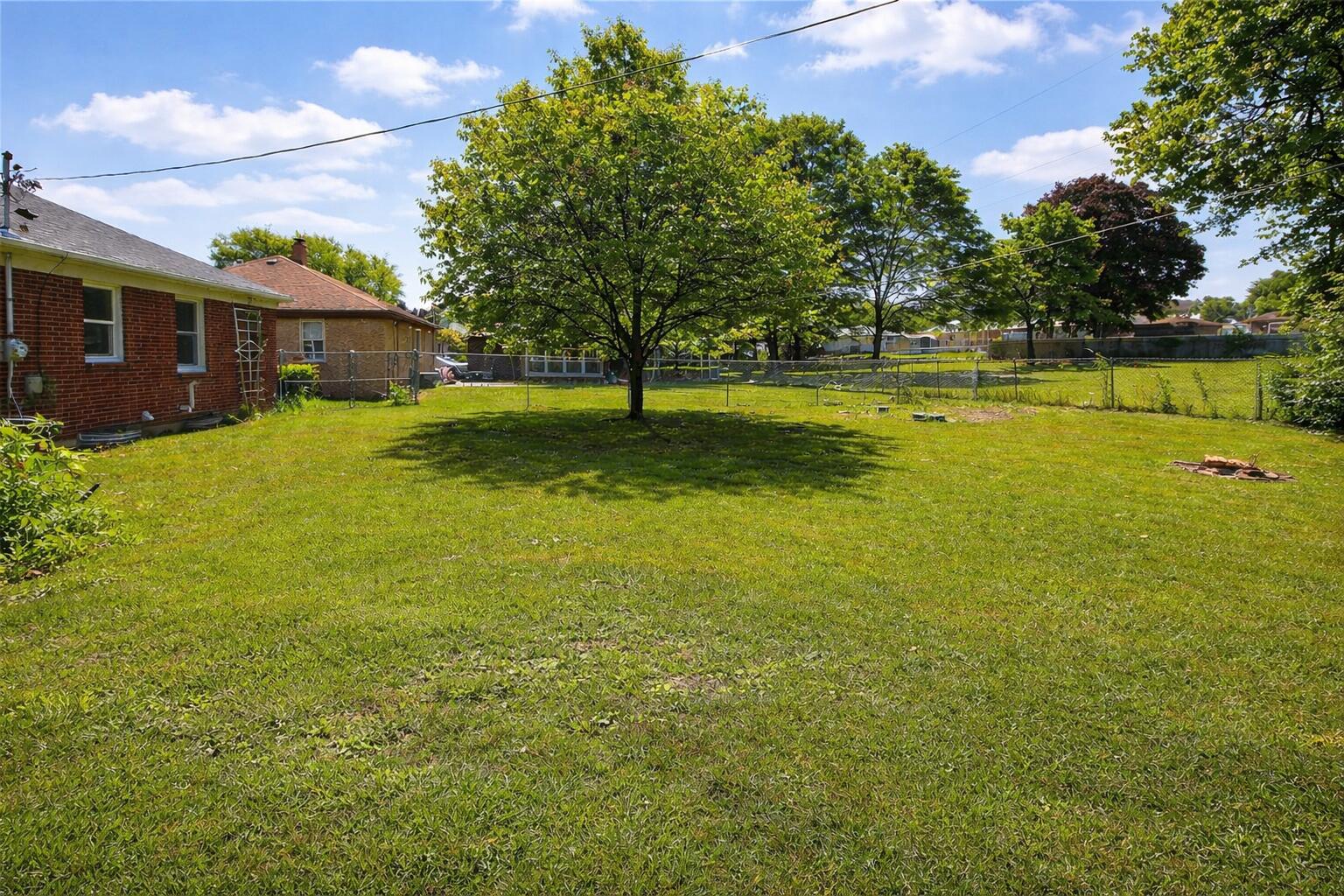 2618 James Boulevard Racine, WI 53403 - Photo 38 of 38 Sunny suburban backyard with a large tre