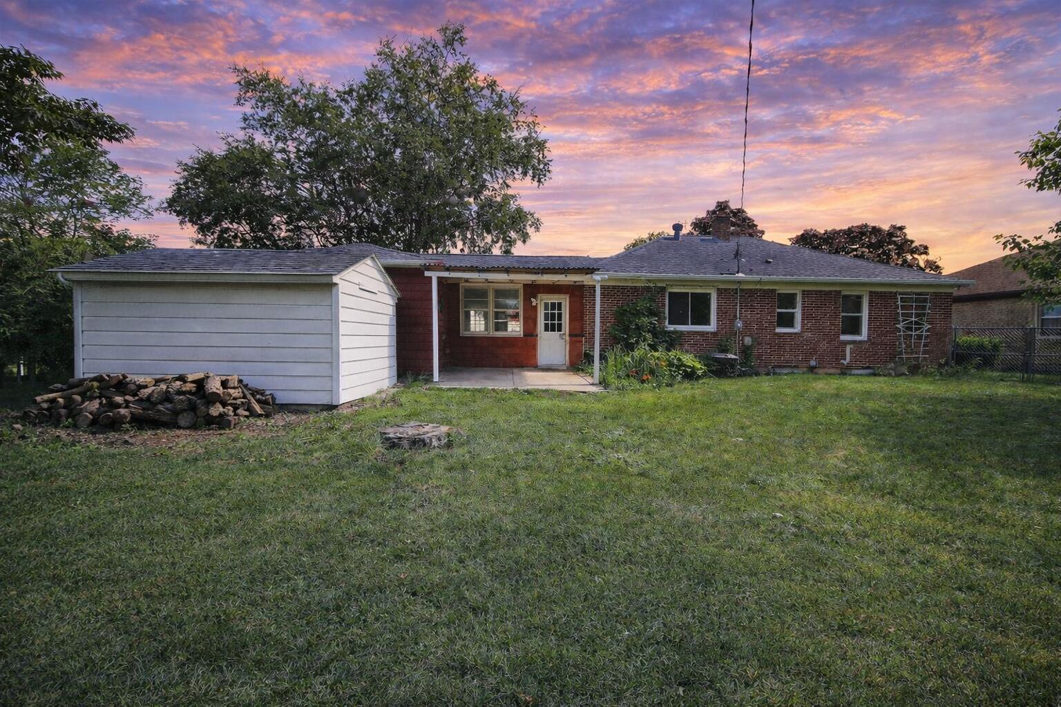 2618 James Boulevard Racine, WI 53403 - Photo 5 of 38 Suburban house at sunset with garden