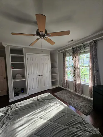 a view of a livingroom with a ceiling fan and window