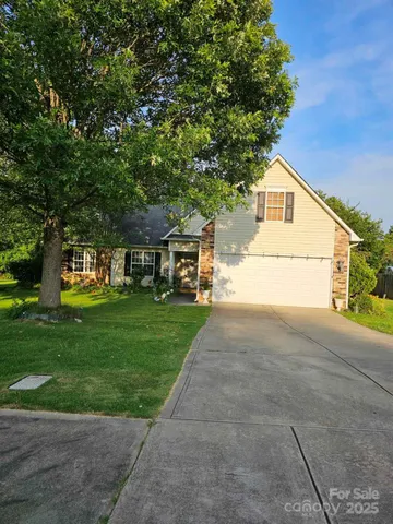 a front view of a house with a yard and a garage