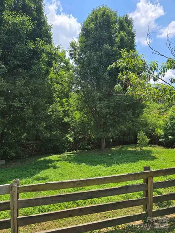 a green field with lots of trees
