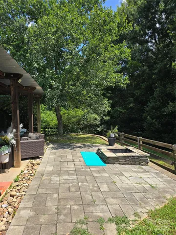 a view of swimming pool with lounge chair and dinning table under an umbrella