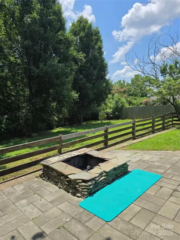 a view of a backyard with a garden and trees