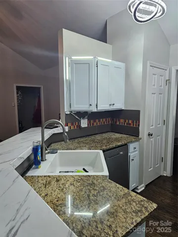 a kitchen with a sink a stove and cabinets