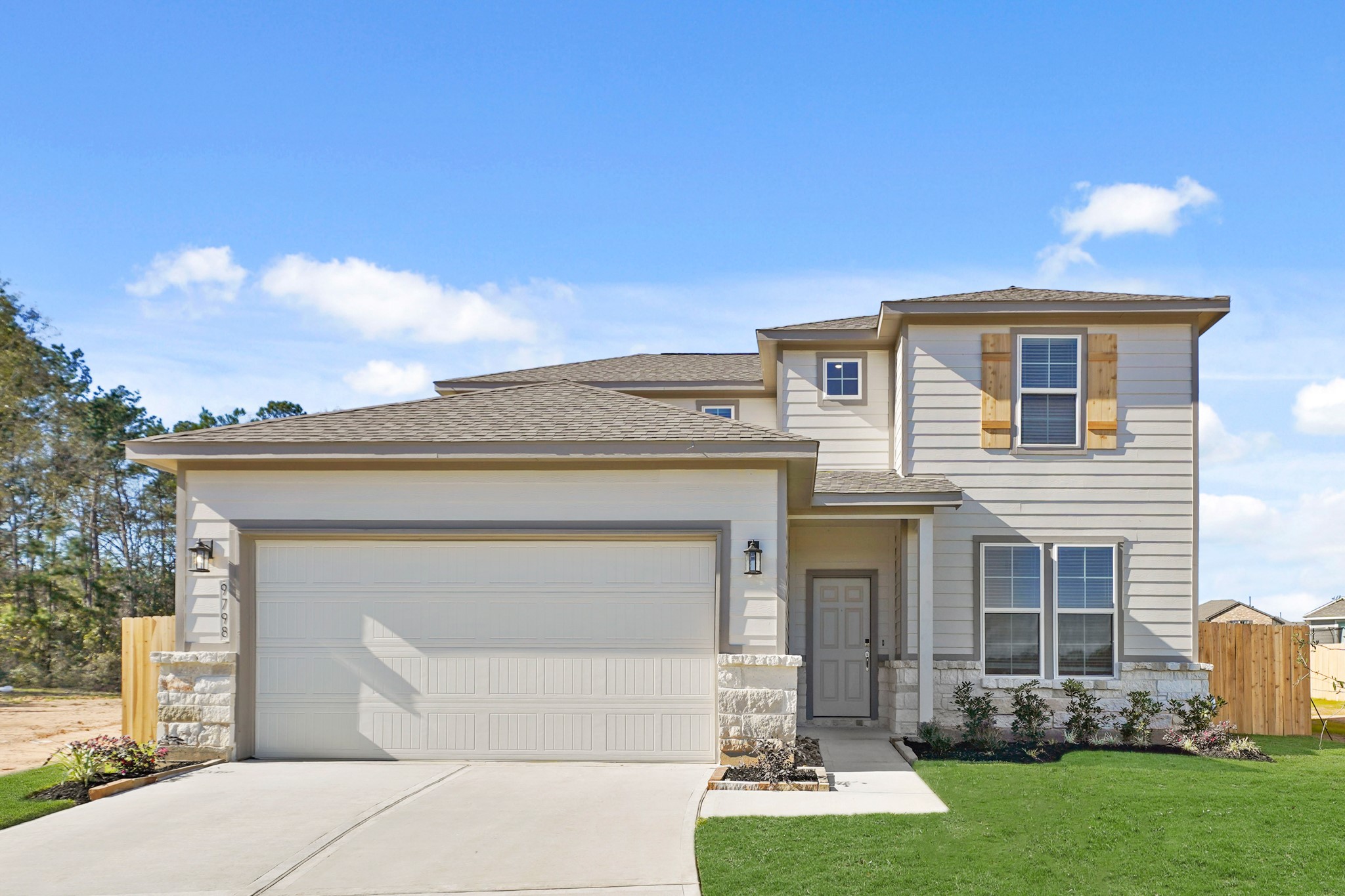 9798 Caney Bend Road Conroe, TX 77303 - Photo 1 of 27 a front view of a house with a yard and garage