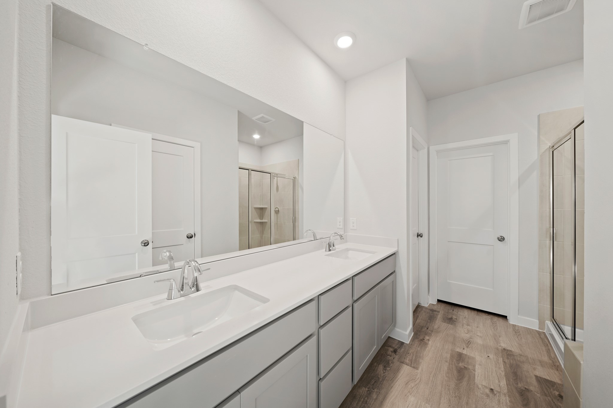 9798 Caney Bend Road Conroe, TX 77303 - Photo 11 of 27 a bathroom with a sink double vanity granite tub shower and a mirror
