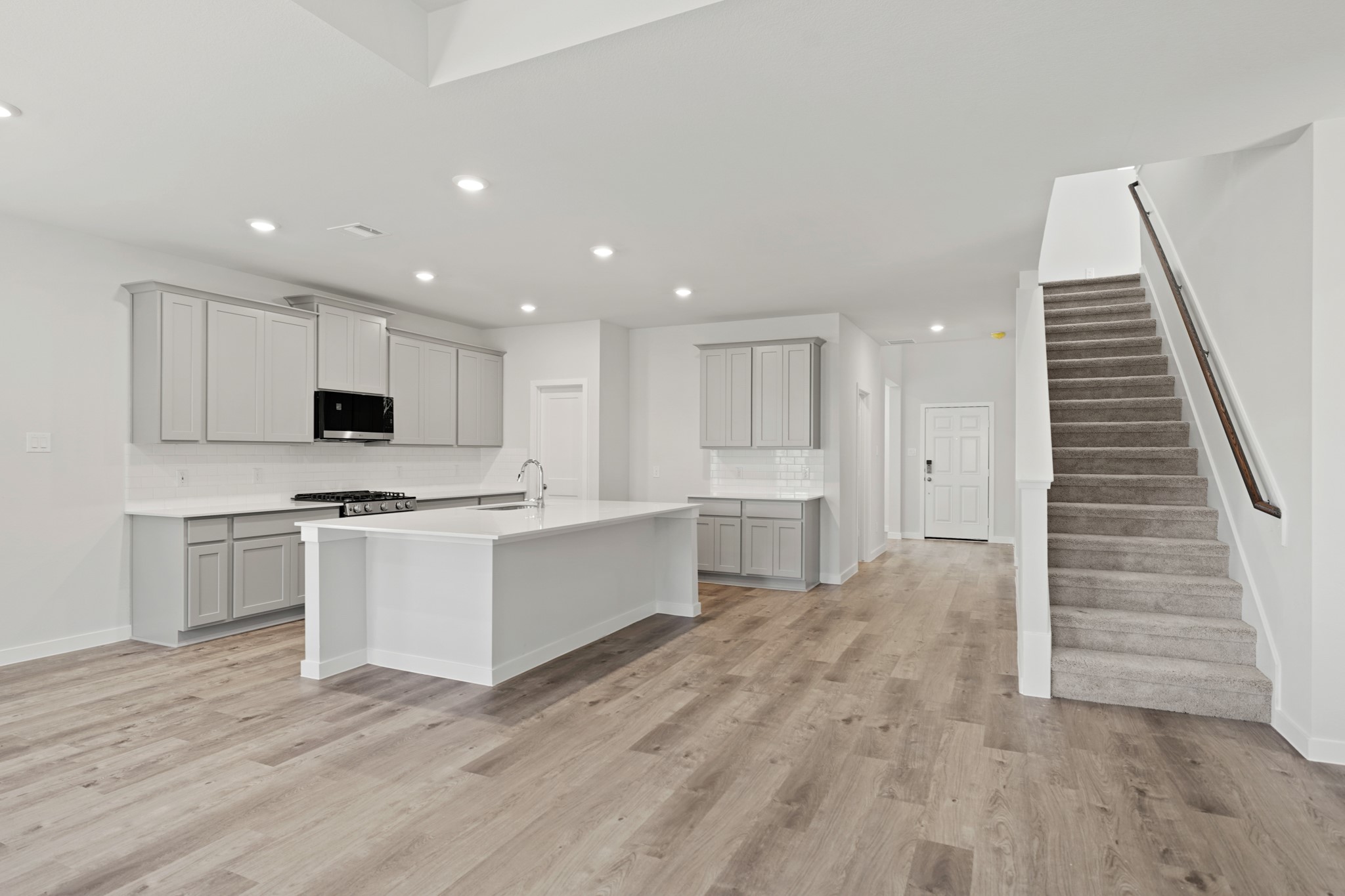 9798 Caney Bend Road Conroe, TX 77303 - Photo 14 of 27 a kitchen with white cabinets and white appliances