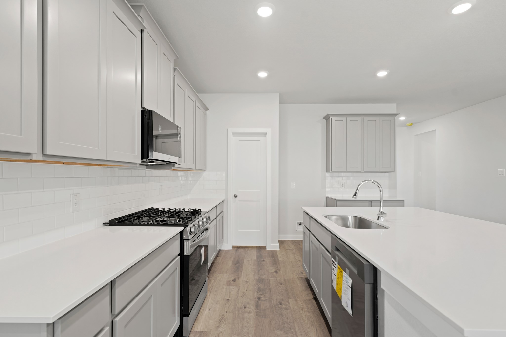 9798 Caney Bend Road Conroe, TX 77303 - Photo 15 of 27 a kitchen with a sink stove and cabinets