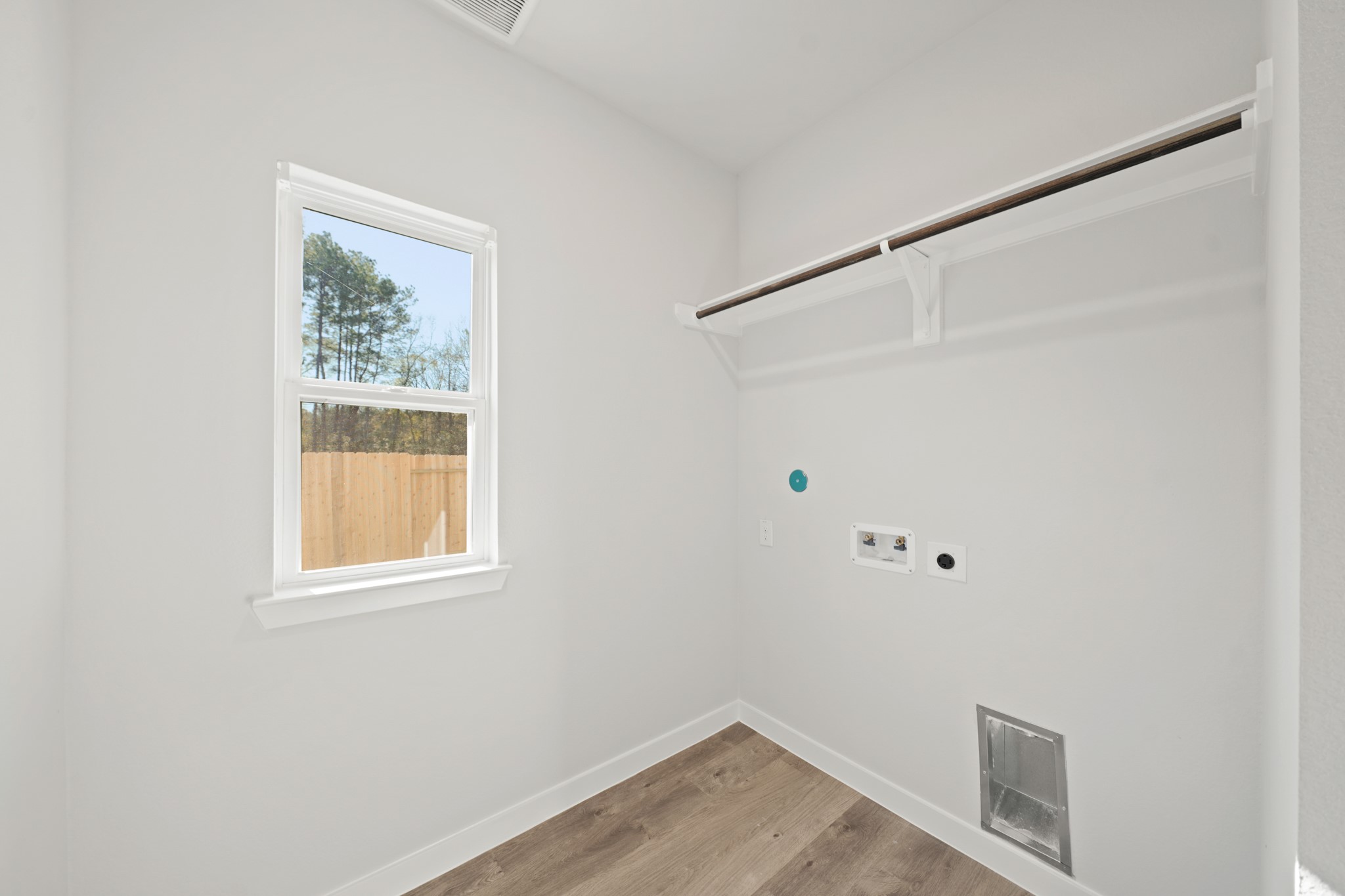 9798 Caney Bend Road Conroe, TX 77303 - Photo 8 of 27 a view of an empty room with wooden floor and a window