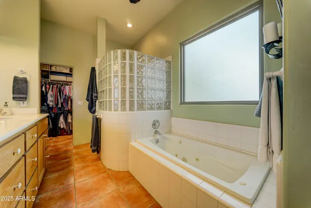 a view of walk in closet with clothes