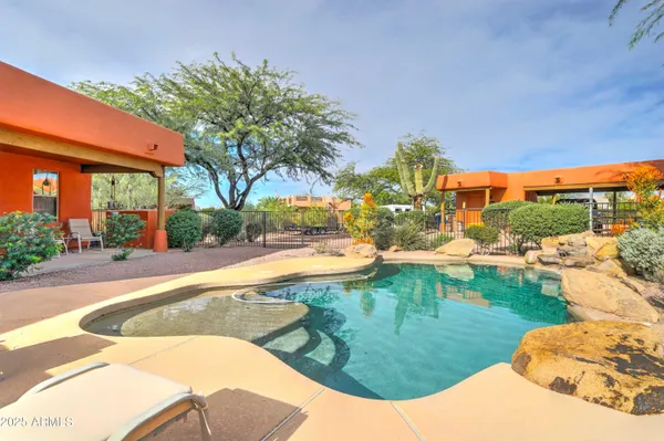an outdoor sitting area with couch and umbrella