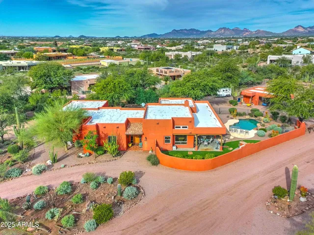an aerial view of residential houses with outdoor space and street view
