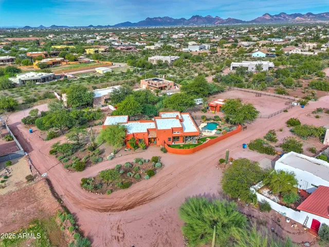 an aerial view of residential houses with outdoor space and street view